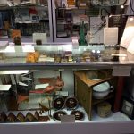 Front display case with miniatures, artist's books, and the illustrious "Thunderbook